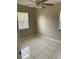 An airy bedroom features neutral walls, tile floors, and a ceiling fan with light fixture at 1626 S Page Dr, Deltona, FL 32725