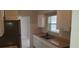 Bright kitchen featuring white cabinets, a stainless steel sink and ample natural light at 1626 S Page Dr, Deltona, FL 32725