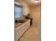 A functional kitchen offers white cabinets, neutral countertops, tile backsplash, and updated appliances at 1626 S Page Dr, Deltona, FL 32725