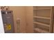 Laundry room with water heater, utility sink, and built-in shelving at 1626 S Page Dr, Deltona, FL 32725