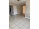 A spacious living room with tile flooring, neutral walls, ceiling fans, and natural light at 1626 S Page Dr, Deltona, FL 32725