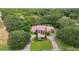 Expansive aerial view of a single-story home with a red tile roof, surrounded by lush landscaping at 1641 Timber Hills Dr, Deland, FL 32724