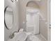 Bright bathroom featuring a white sink, toilet, and shower with a clear glass enclosure and decorative arch at 1641 Timber Hills Dr, Deland, FL 32724