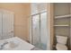 Bathroom featuring a sink, toilet, glass-enclosed shower, and floating shelves on the wall at 1641 Timber Hills Dr, Deland, FL 32724