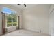 Bedroom features large windows, neutral carpet, and natural light for a relaxing atmosphere at 1641 Timber Hills Dr, Deland, FL 32724