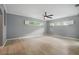 A spacious bedroom is shown with hardwood flooring, gray walls, ceiling fan, and windows at 1641 Timber Hills Dr, Deland, FL 32724