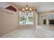 Bright dining area with tile floors, chandelier, large windows, and view of screened pool at 1641 Timber Hills Dr, Deland, FL 32724