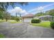 Exterior view of a home with a garage, screened-in pool area, and lush landscaping at 1641 Timber Hills Dr, Deland, FL 32724