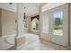 Inviting foyer with elegant tile flooring, a decorative chandelier, and large windows that fill the space with natural light at 1641 Timber Hills Dr, Deland, FL 32724