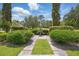 Beautifully landscaped front yard with lush greenery, manicured bushes, and a charming fountain feature at 1641 Timber Hills Dr, Deland, FL 32724
