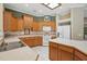 Well-lit kitchen with wooden cabinetry, a center island, modern appliances, and an open layout connecting to the living space at 1641 Timber Hills Dr, Deland, FL 32724