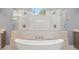 Close up of a main bathroom with separate vanities, walk-in shower, and freestanding soaking tub at 1641 Timber Hills Dr, Deland, FL 32724