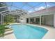 Screened-in pool area with a clear blue pool, patio furniture, and a red tile roof home at 1641 Timber Hills Dr, Deland, FL 32724