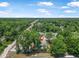 Aerial view of home and surrounding area, railroad tracks in distance at 1890 15Th St, Orange City, FL 32763
