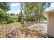 Backyard view featuring lush trees and ample open space, perfect for outdoor activities at 1890 15Th St, Orange City, FL 32763