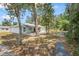 A home nestled among trees features a spacious backyard, offering a serene outdoor escape at 1890 15Th St, Orange City, FL 32763