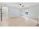 View of a neutral bedroom with tile floor, window, ceiling fan and ensuite access at 1890 15Th St, Orange City, FL 32763