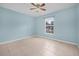 Empty bedroom with tile flooring, ceiling fan, and window at 1890 15Th St, Orange City, FL 32763