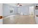 View of a neutral bedroom with tile floor, window, ceiling fan and ensuite access at 1890 15Th St, Orange City, FL 32763