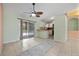 Open dining area with tile flooring, a ceiling fan, sliding glass doors to the patio, and a breakfast bar at 1890 15Th St, Orange City, FL 32763