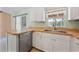 Bright kitchen with white cabinets, stainless steel dishwasher, and breakfast bar at 1890 15Th St, Orange City, FL 32763