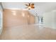 Spacious living room with tile flooring, neutral walls, ceiling fan, and sliding glass doors to the patio at 1890 15Th St, Orange City, FL 32763