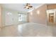 Inviting living room with tile floors, modern lighting, neutral walls, and a view of the front entry at 1890 15Th St, Orange City, FL 32763