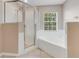 Bright bathroom featuring a glass shower, bathtub, and natural light at 1922 Cove Point Rd, Port Orange, FL 32128