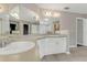 Bathroom with a double sink vanity and large mirror at 1922 Cove Point Rd, Port Orange, FL 32128