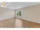 Bright bedroom featuring hardwood floors, a ceiling fan, and a window with natural light at 1922 Cove Point Rd, Port Orange, FL 32128
