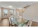Open concept room with a dining table and stairway in view, featuring tile and wood flooring at 1922 Cove Point Rd, Port Orange, FL 32128