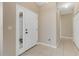 Bright entryway with tile flooring, white front door with glass panes and neutral wall paint at 1922 Cove Point Rd, Port Orange, FL 32128