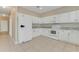 Bright kitchen features white cabinets, countertops and appliances, along with tile flooring at 1922 Cove Point Rd, Port Orange, FL 32128