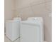 Laundry area featuring a white washer and dryer with overhead shelving at 1922 Cove Point Rd, Port Orange, FL 32128