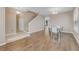 Open concept room with a dining table and stairway in view, featuring tile and wood flooring at 1922 Cove Point Rd, Port Orange, FL 32128