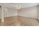 Open-concept living room with light walls, hardwood floors, and a ceiling fan at 1922 Cove Point Rd, Port Orange, FL 32128