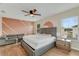 Main bedroom features a textured wall, modern furniture and wood floors at 1922 Cove Point Rd, Port Orange, FL 32128