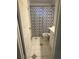 Narrow bathroom featuring a toilet, sink, and shower with a patterned curtain at 2219 Howland Blvd, Deltona, FL 32738