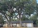 Charming single-story home with mature trees and a cozy front porch at 2219 Howland Blvd, Deltona, FL 32738