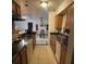 Eat-in kitchen with wood cabinetry, stainless steel appliances, and an adjacent dining area at 2219 Howland Blvd, Deltona, FL 32738