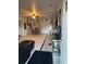 Open-concept living and dining area with tile floors, ceiling fans, and a decorative fireplace at 2219 Howland Blvd, Deltona, FL 32738