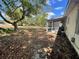 Spacious backyard featuring a large tree, a screen porch, an A/C unit, and lots of shade at 2332 Hadley St, Deltona, FL 32738