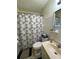 Bathroom featuring a shower with a leaf patterned curtain, a tiled shower wall, and vanity sink at 2332 Hadley St, Deltona, FL 32738