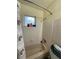 Clean bathroom featuring a tiled shower, tub, and a large window for natural light at 2332 Hadley St, Deltona, FL 32738