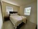 Bedroom with natural lighting and floral patterned bedcover, providing a tranquil sanctuary at 2332 Hadley St, Deltona, FL 32738
