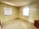 Bedroom with speckled flooring and two windows at 2332 Hadley St, Deltona, FL 32738