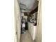 Functional laundry room with washer, dryer, storage, and utility sink offers convenience and efficiency at 2332 Hadley St, Deltona, FL 32738