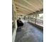 Relaxing screened porch features ample sunlight, a comfortable lounge, and space for entertaining at 2332 Hadley St, Deltona, FL 32738