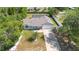 Aerial view of the single Gathering home, fenced back yard, and proximity to trees at 2416 Candlewick St, Deltona, FL 32738