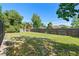 Spacious backyard with a green lawn and wood fence, offering plenty of room for outdoor activities at 2416 Candlewick St, Deltona, FL 32738
